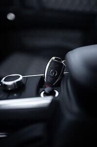 Car key inserted into lock blocking automated gear unit of modern car